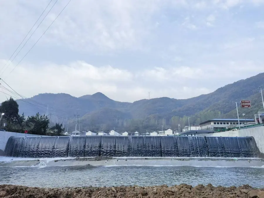 Completed dam retaining water in a mountain valley