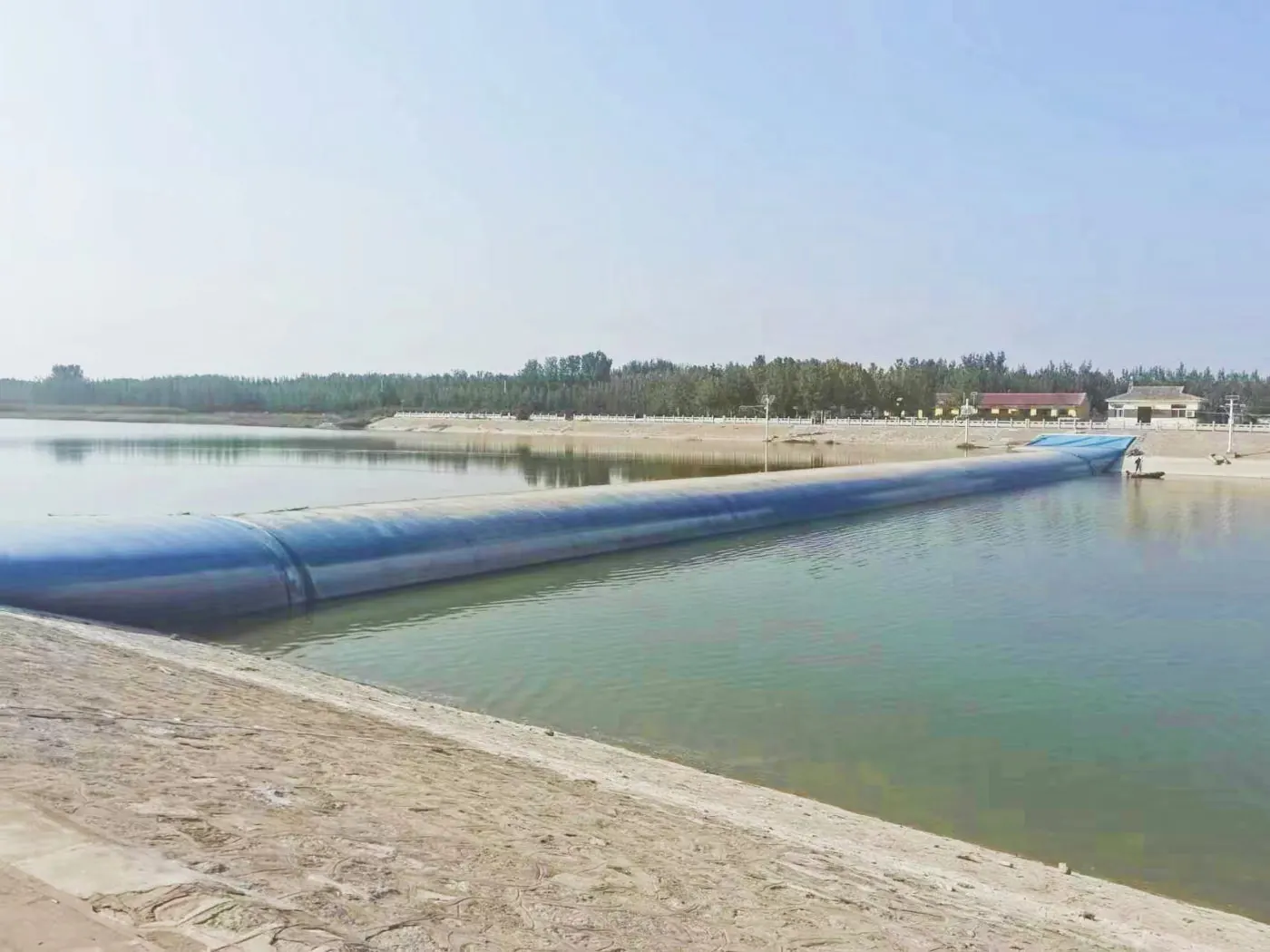 Rubber dam retaining water in a plain river