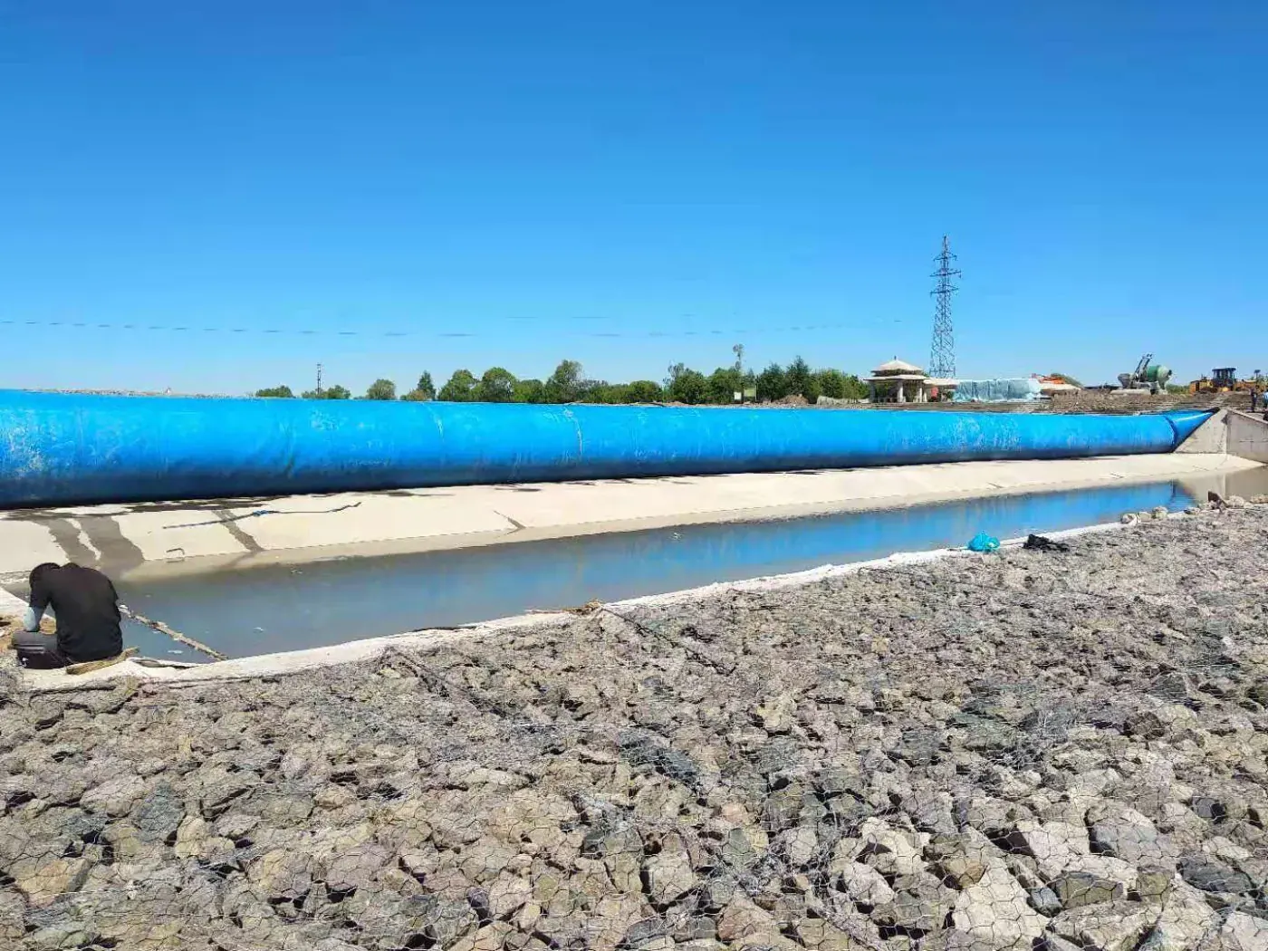 Inflated rubber dam retaining water on a river