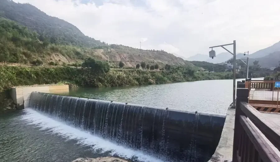 Blue rubber dam bag in a town river